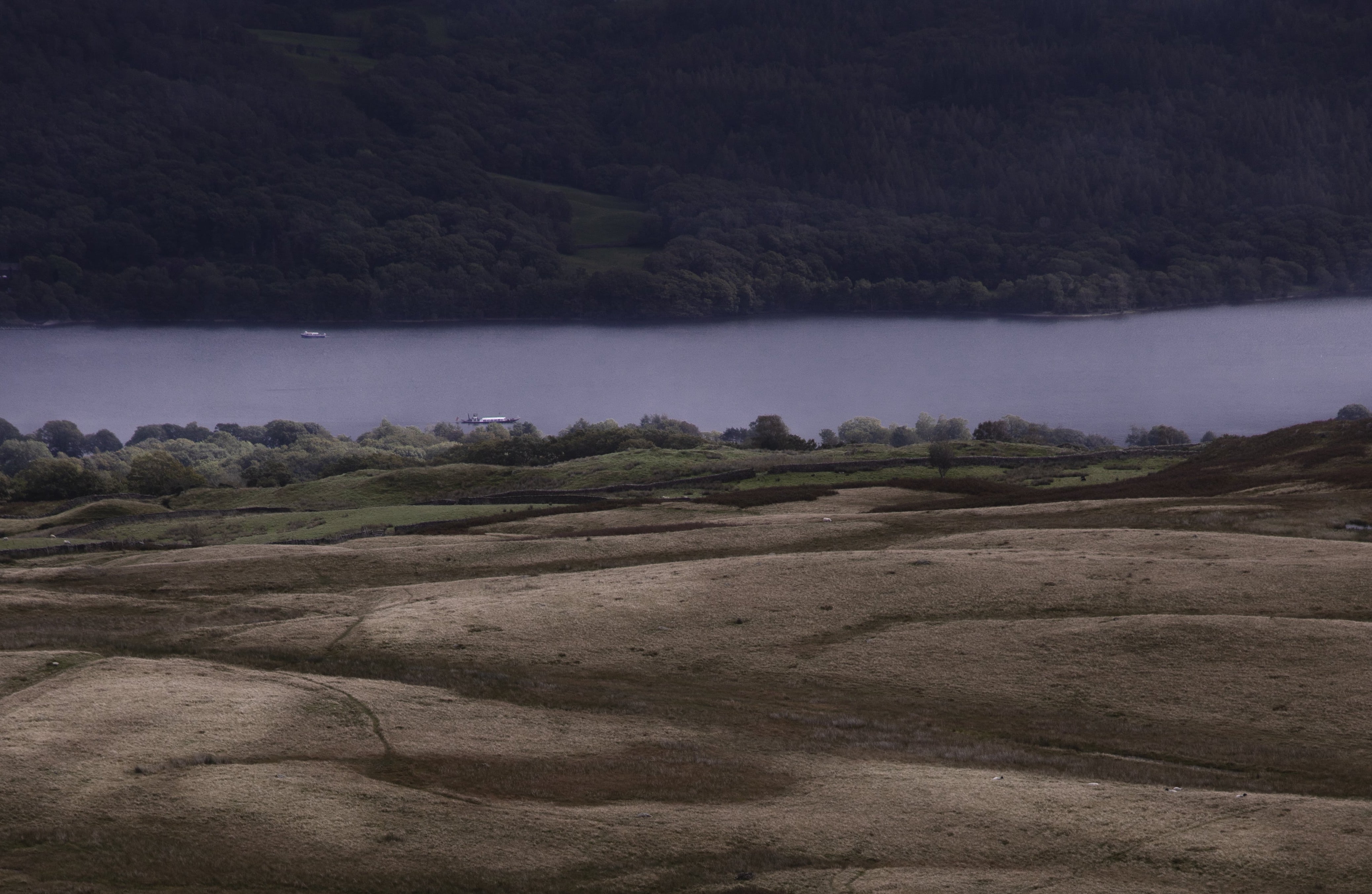 Looking down a valley onto boats on a lake