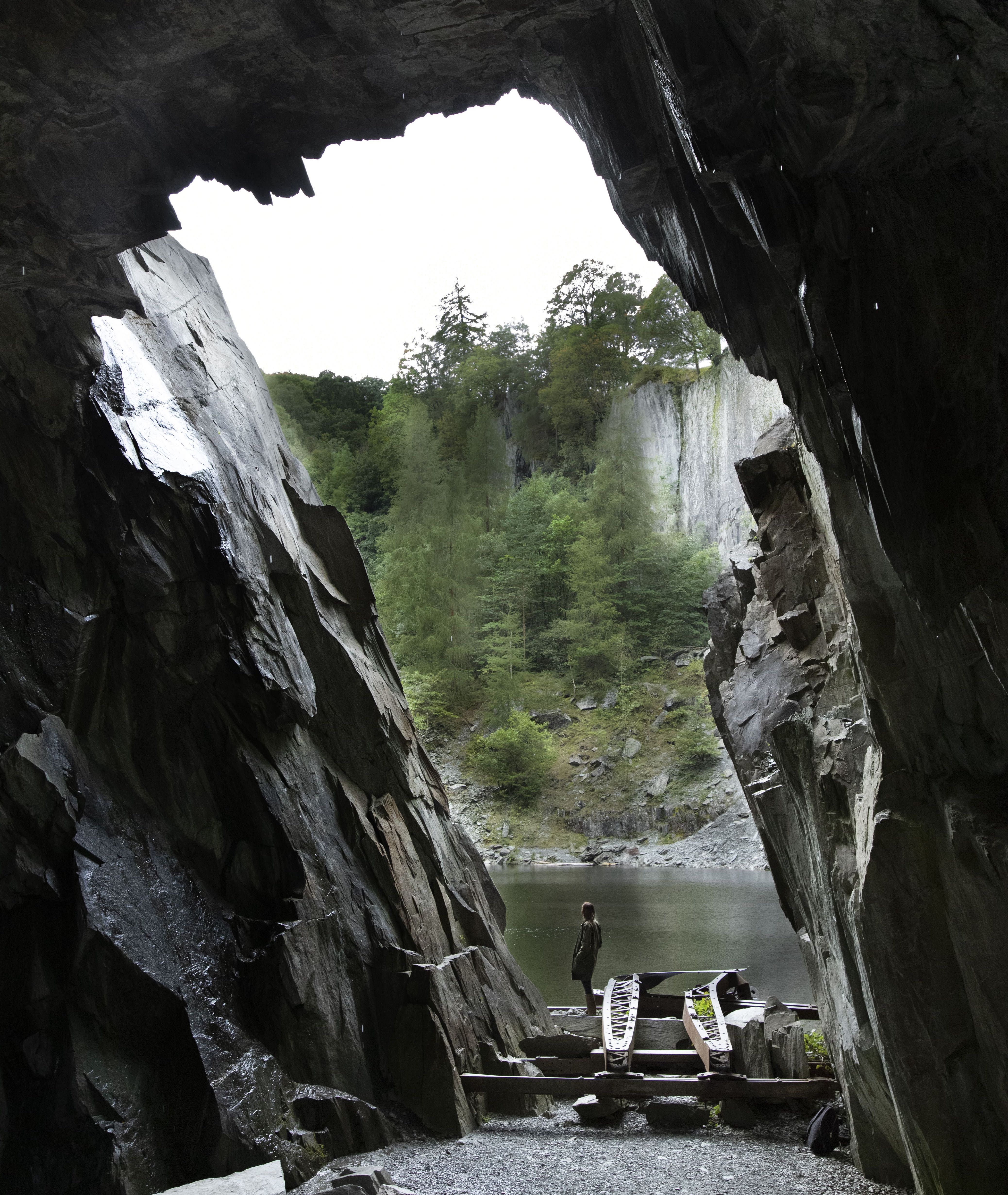 View through a cave opening looking at a lake