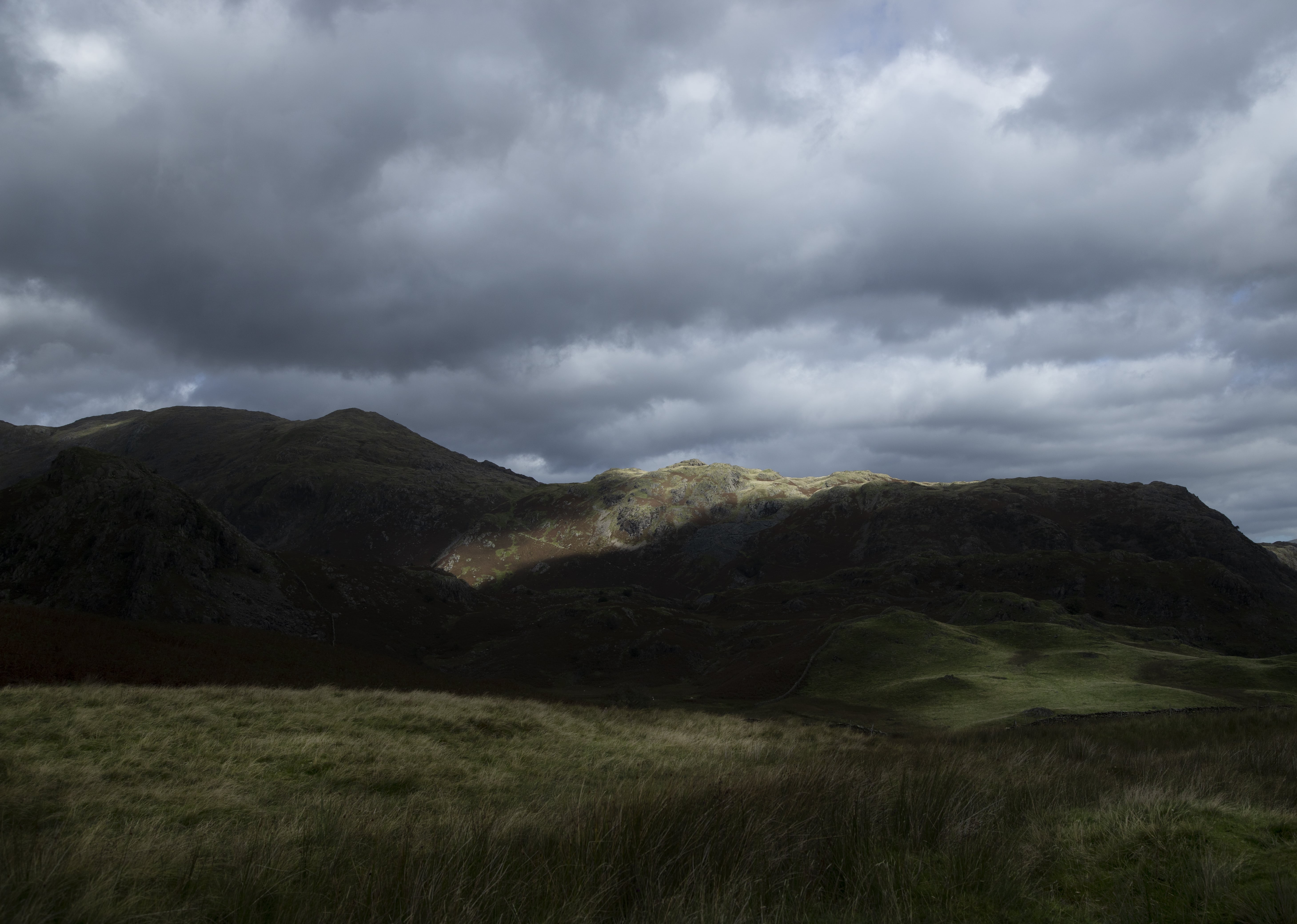 Hills in the lake district with sun shinning through the clouds